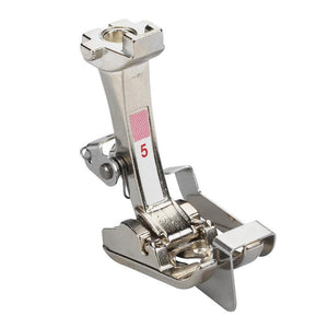 Metal sewing machine presser foot on a white background Metal sewing machine presser foot on a white background