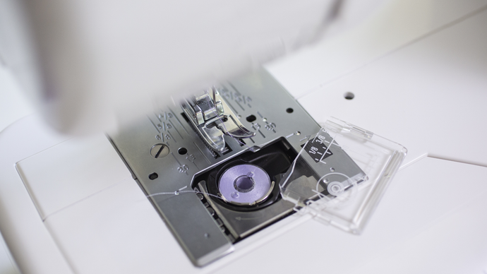 Close-up of a Baby Lock Zeal sewing machine needle plate on a white background