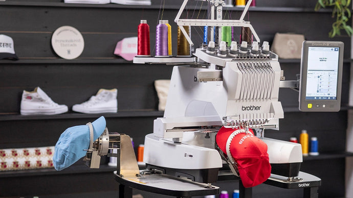 Brother embroidery machine on a stand with various items in the background