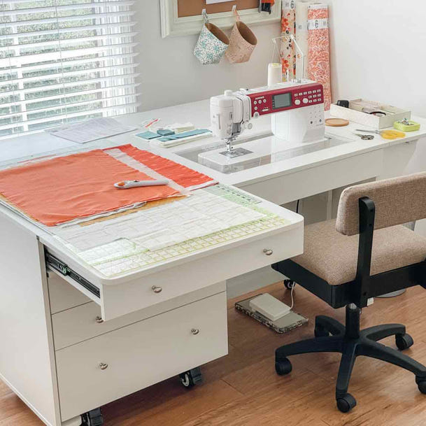 Sewing desk with a chair in a home office setting